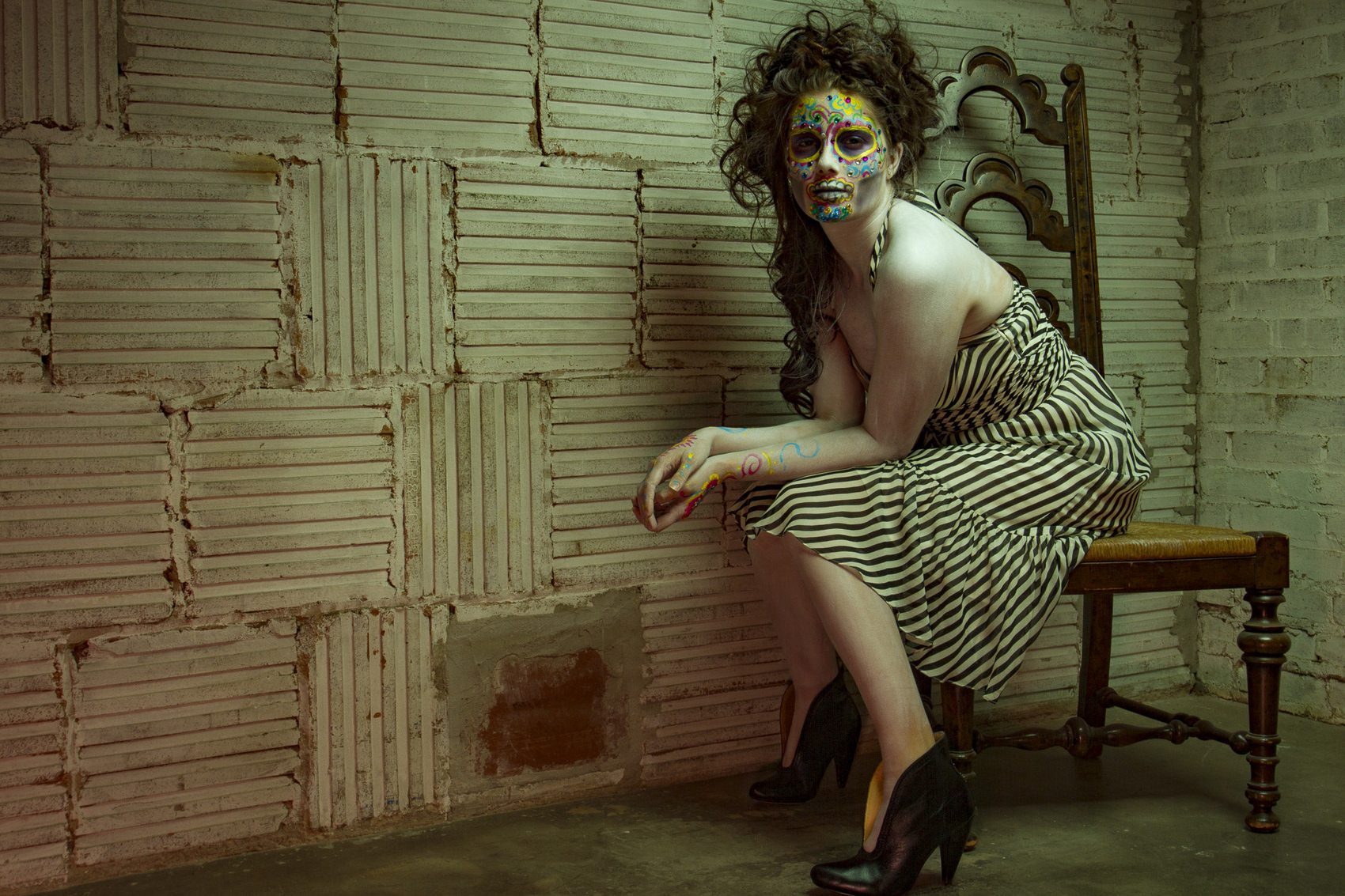 Fashion editorial with painted face and striped dress