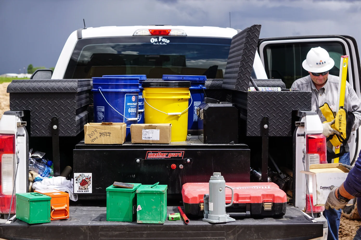 Worker caught between tasks at the back of a field truck
