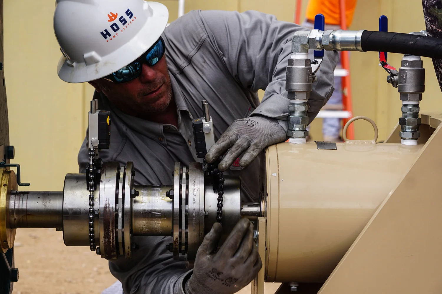 Technician making a precise adjustment on rotating equipment