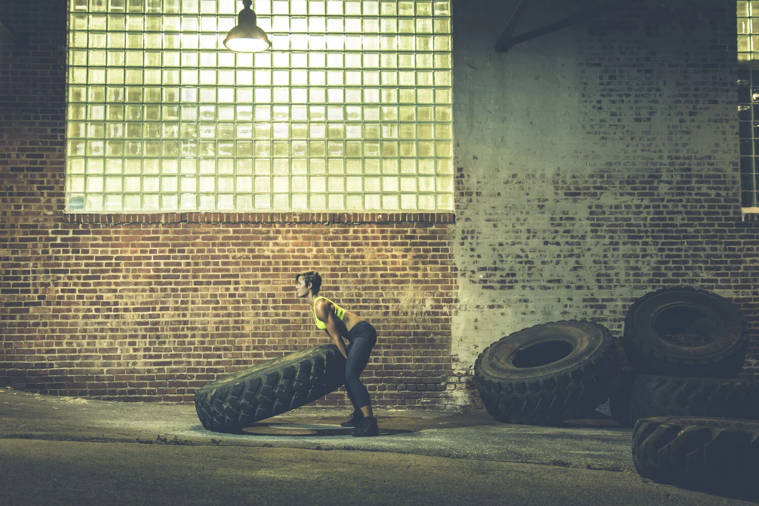 Athlete pushing through a tire training movement