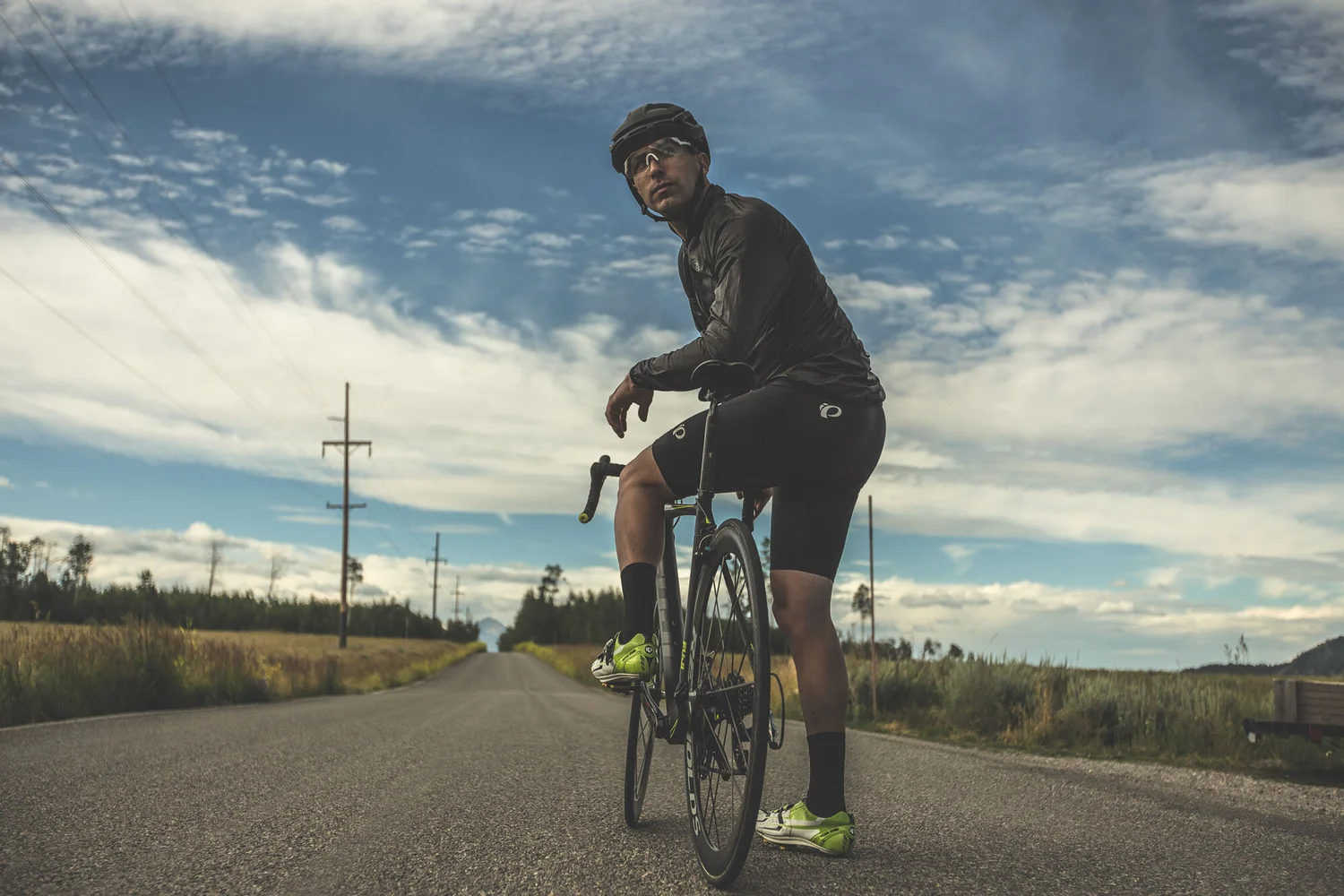 Cyclist riding under a wide western sky