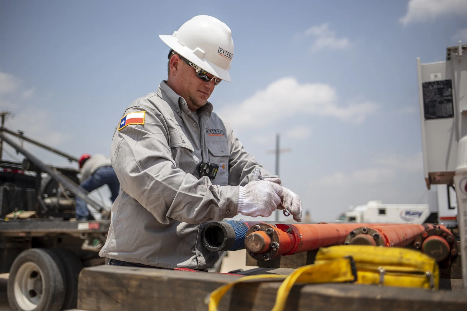 Industrial worker making a close adjustment on active equipment