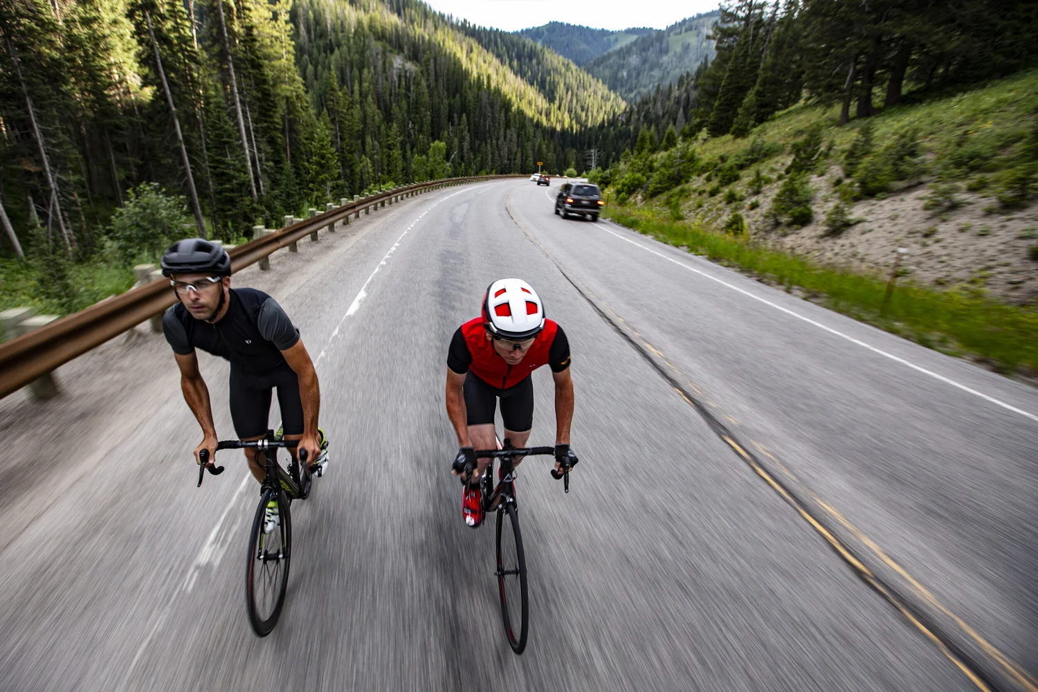 Two cyclists photographed from above on a mountain road