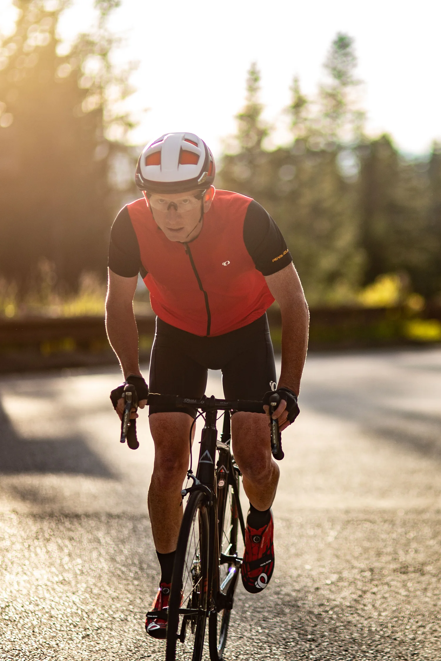 Cyclist driving through warm backlight at speed