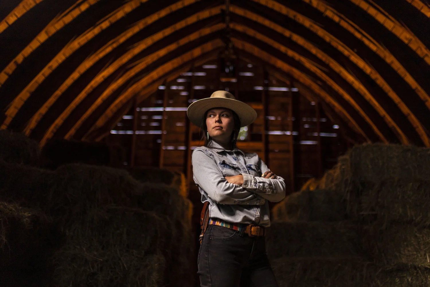 Western portrait framed by the structure of a working barn