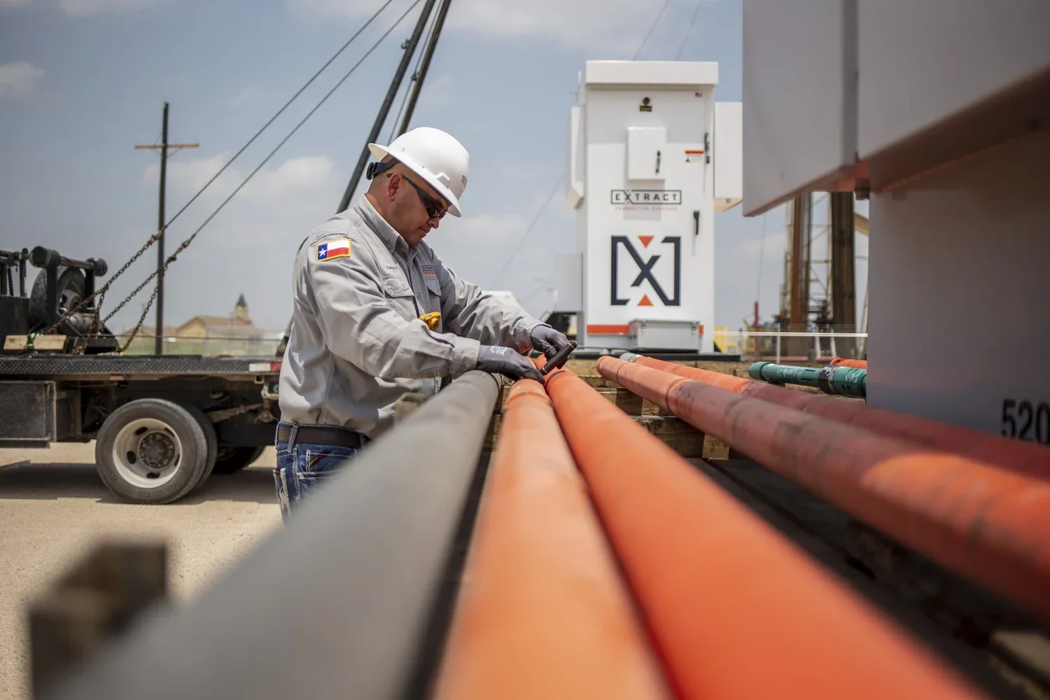 Long industrial pipe lines creating depth across an active field site