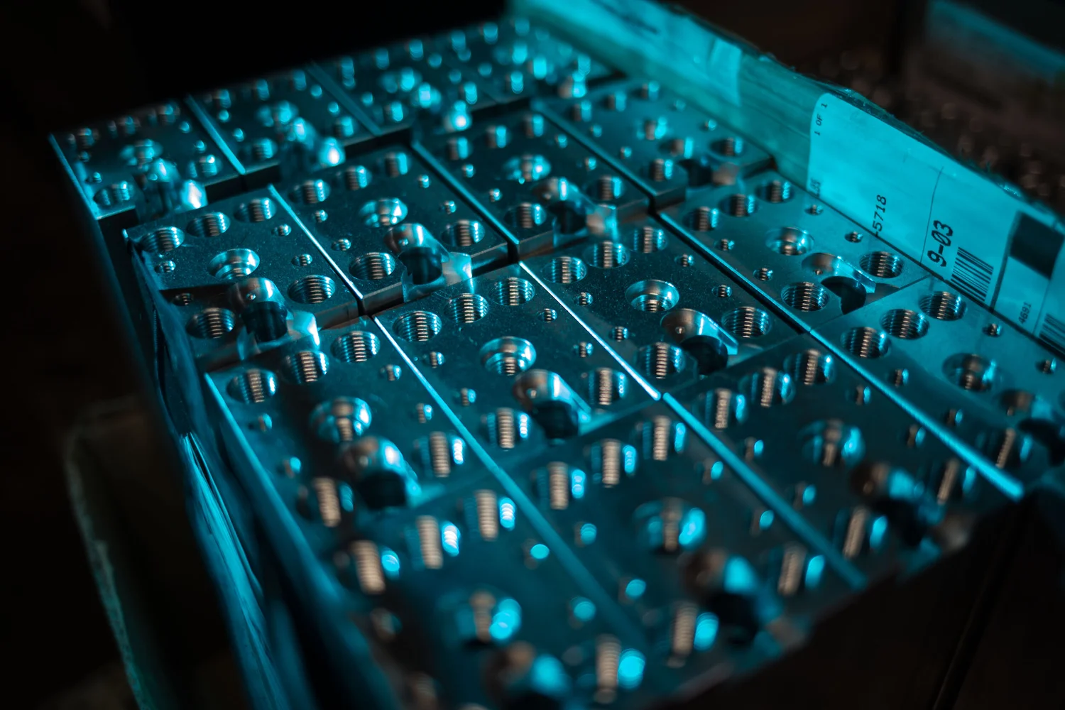 Repeated machined forms photographed as an industrial pattern