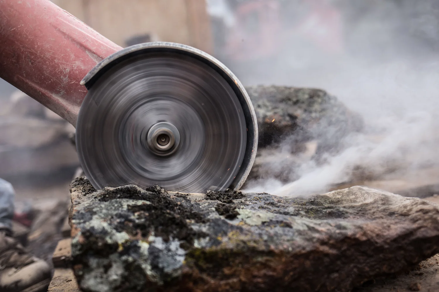 Worker cutting material on site