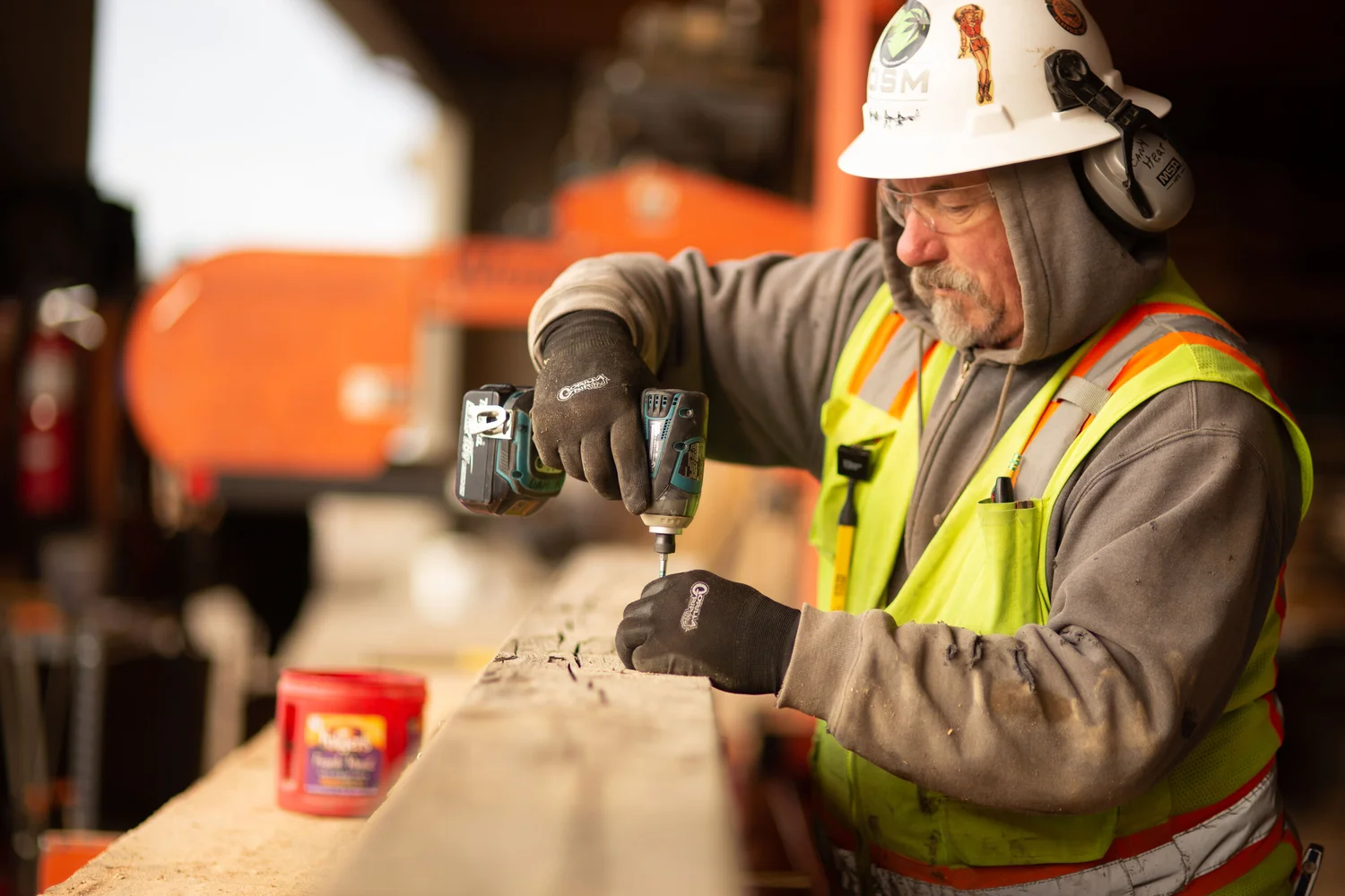 Worker using a drill on site